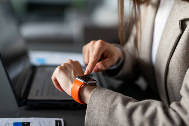 istock Businesswoman with smartwatch at work 2203733838
