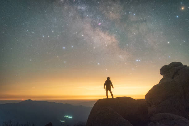 istock A man standing on the mountaintop admiring the vast Milky Way 2203734193