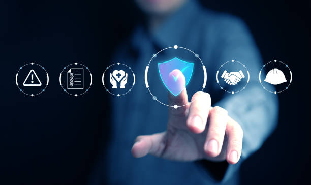 istock Work safety and compliance. A man with safety first icons, including a shield, warning sign, checklist, helmet, handshake, and healthcare symbol. 2203734483