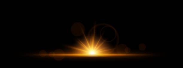 istock Glowing yellow light burst on a dark background. Bright neon explosion with radiant beams, circular bokeh, and energy flare. Abstract illumination with vibrant glow and futuristic effect. 2203734577