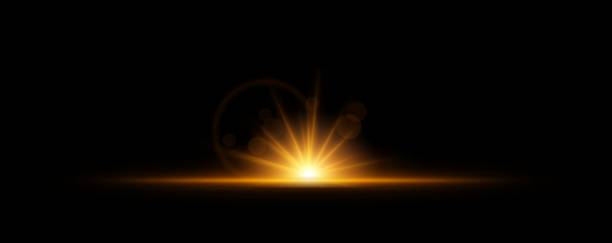 istock Glowing light burst on a dark background. Bright orange energy explosion with radiant beams and bokeh effects. Abstract illumination with dynamic flare and glowing particles 2203734592
