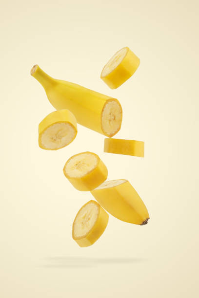 istock Banana pieces falling on yellow background 2203735285