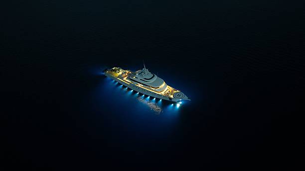 istock Luxurious yacht illuminated at night in dark ocean waters. 2203735492