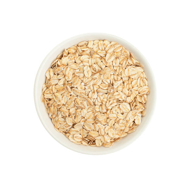 istock Raw oat flakes in a white plate on a white background 2203738260