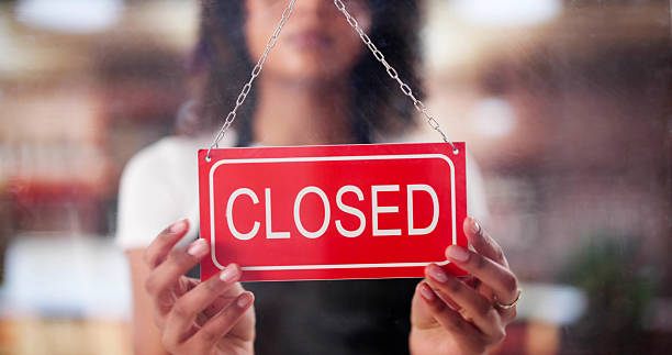 istock Female Owner Changing Open Sign 2203738380