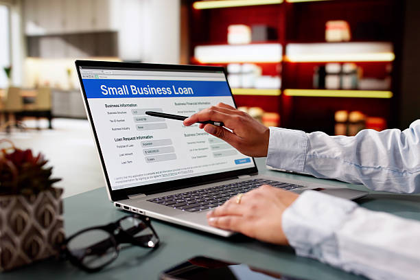 istock Person Hand Over Small Business Loan Application 2203738494