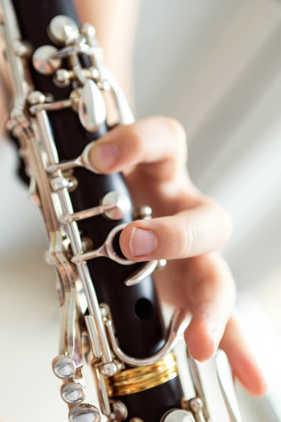 istock close up of child's hands playing clarinet, selective focus 2203741894