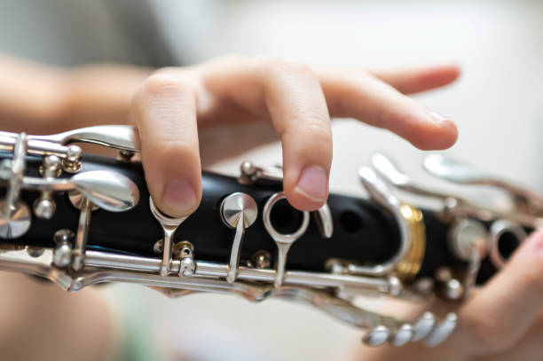 istock close up of child's hands playing clarinet, selective focus 2203741901