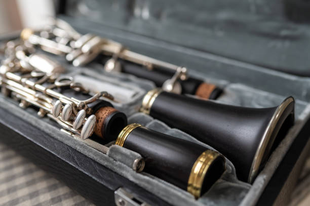 istock A black clarinet rests in an open case with a plush interior. The selective focus highlights its silver keys and sleek body, while the blurred background adds depth. A perfect shot for music and instrument themes. 2203742030