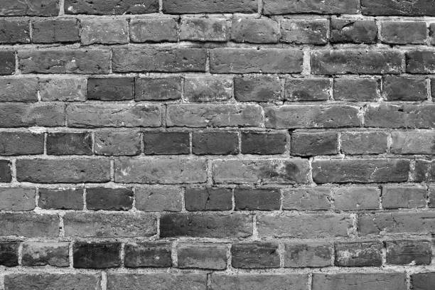 istock Wall background of dark grey bricks. Grey brick wall background. Dark grey wall closeup. 2203744976