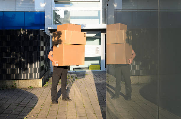 istock Delivery man holds the big boxes. 2203745250
