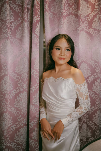 istock Cheerful Young Asian Beautiful Bride in Satin and Lace 2203746498