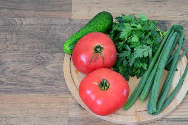 Fresh vegetables on a wooden cutting board.