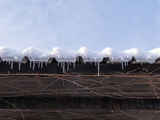 istock Snow-covered roof with icicles 2203748589