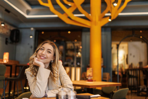 istock Beautiful young woman in restaurant 2203749738