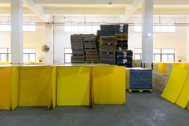Stacked wooden pallets and yellow plastic containers ready for transportation