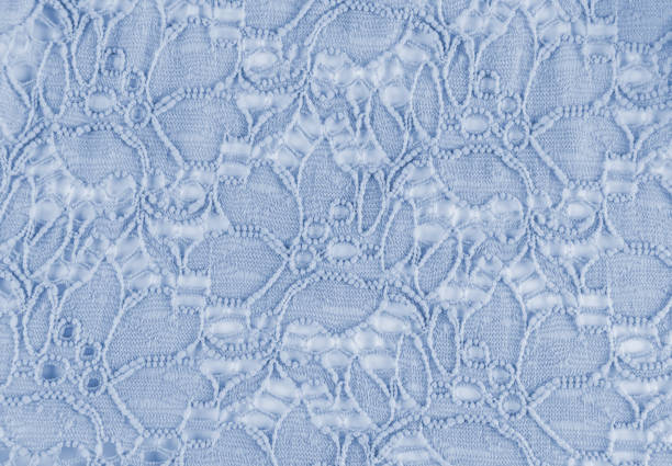 beautiful delicate blue background of openwork fabric. Light floral ornament material. A copy space. The concept of a wedding holiday background