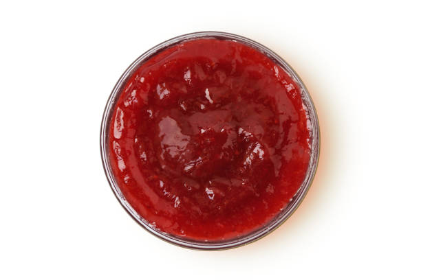 istock Strawberry jam in glass bowl on white background 2203752729