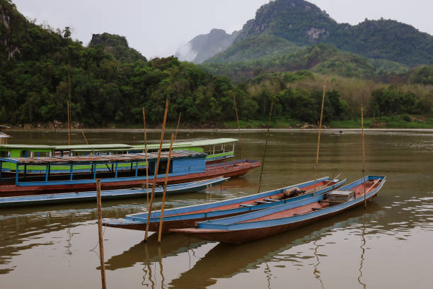 istock Exploring tranquil boats on Mamok River in Mekong Delta Laos during a cloudy afternoon 2203753124