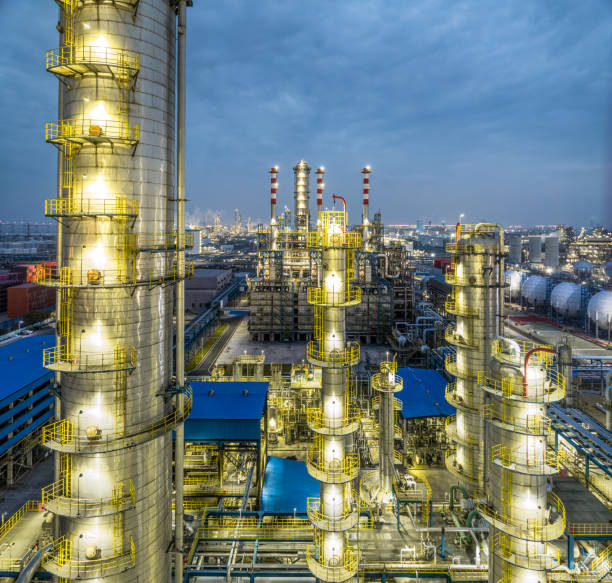 istock Illuminated chemical plant at dusk with blue sky 2203753213