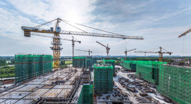 istock Construction site with crane, building and green net safety at summer 2203753416