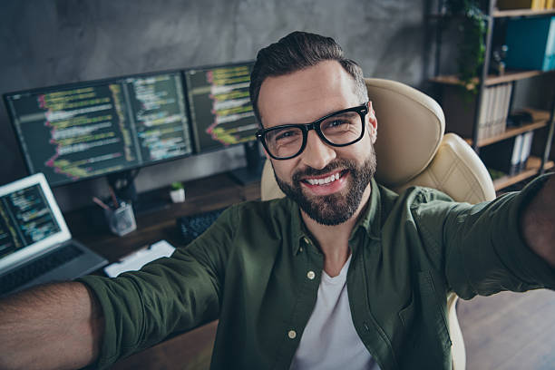 istock Self-portrait of attractive cheerful intellectual guy working remotely employment tech support at workplace station indoors 2203754889