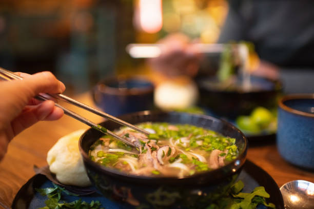 istock People eating Vietnamese dish Pho soup in a cafe 2203762587