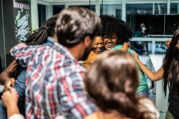istock Successful business team celebrating and embracing in the office 2203765067