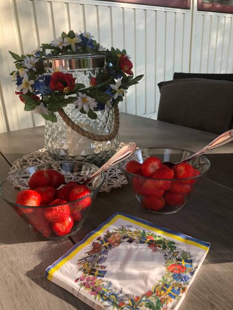 Summer objects in a garden -  strawberry cake and a bouquet with summer flowers