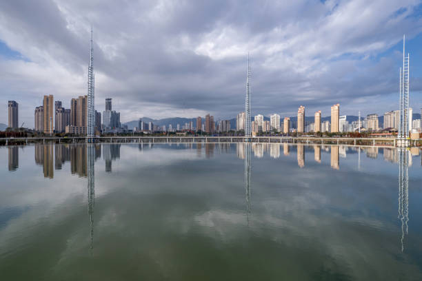 istock The urban architectural complex reflected by the lake water 2203766942