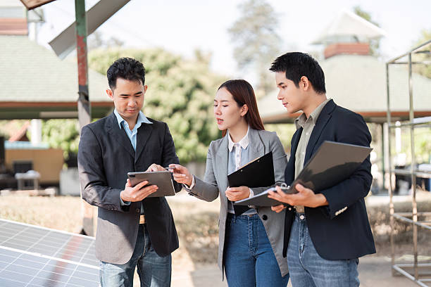 istock Sustainable business initiative. Professionals analyzing solar energy data outdoors. 2203767067
