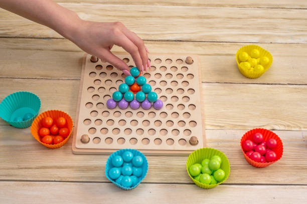 istock a children's game that develops fine motor skills and logical thinking in children according to the Montessori system. 2203768013