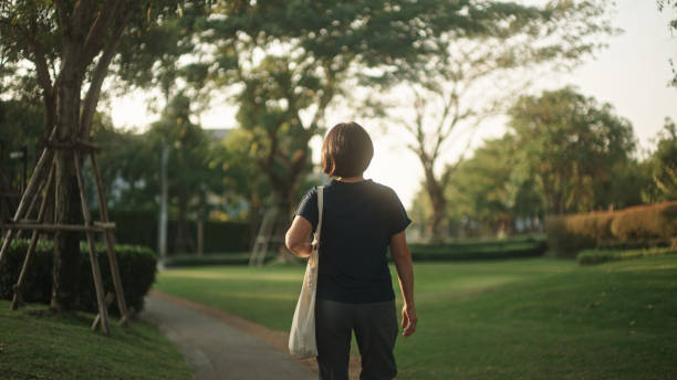 istock Woman walking with reusable shopping bag. 2203768740