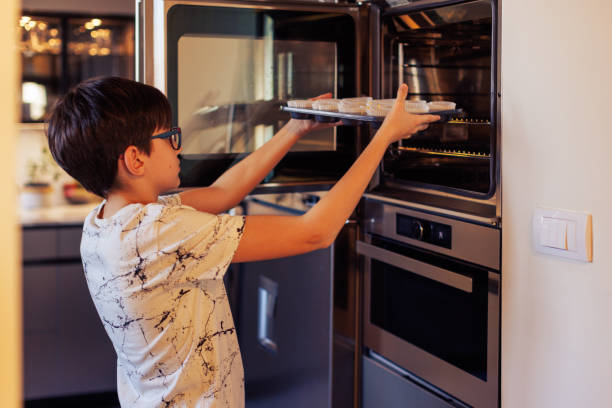 istock 10-Year-Old Boy Baking Muffins in a Home Kitchen 2203768896