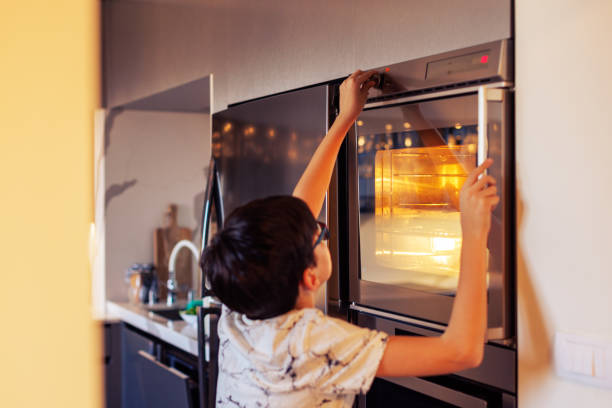 istock 10-Year-Old Boy Baking Muffins in a Home Kitchen 2203768899