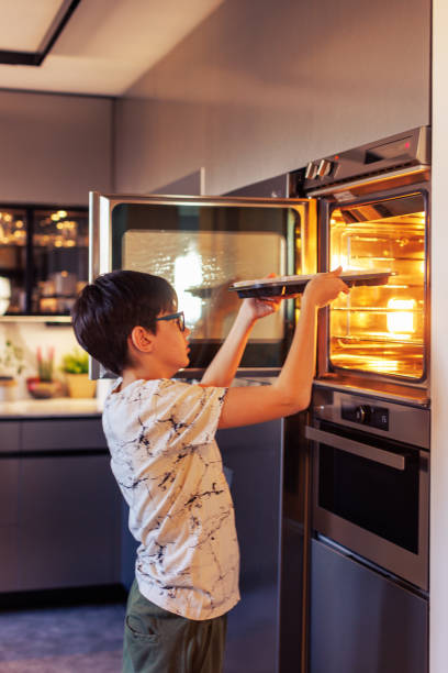 istock 10-Year-Old Boy Baking Muffins in a Home Kitchen 2203768908