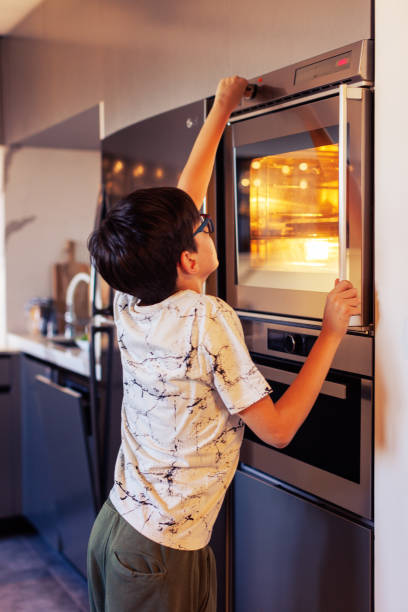 istock 10-Year-Old Boy Baking Muffins in a Home Kitchen 2203768909