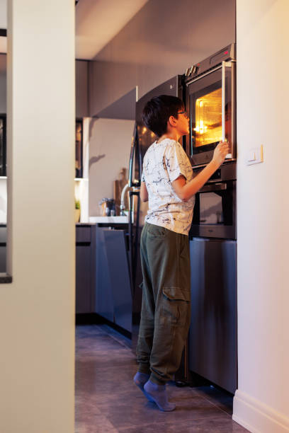 istock 10-Year-Old Boy Baking Muffins in a Home Kitchen 2203768914