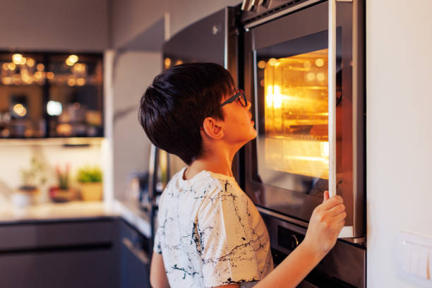 istock 10-Year-Old Boy Baking Muffins in a Home Kitchen 2203768917