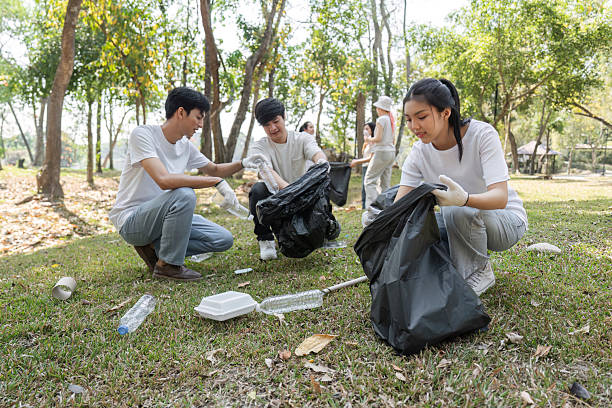 istock Volunteers actively collecting waste during a community cleanup, promoting environmental sustainability. 2203770429