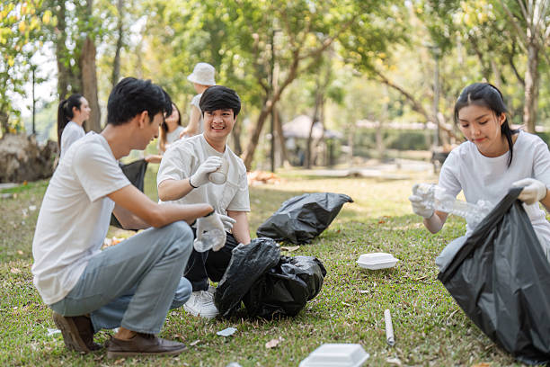 istock Dedicated volunteers sorting trash during a community cleanup, promoting eco-friendly practices and teamwork. 2203770498