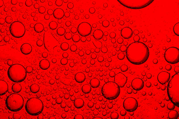 istock Red bubble macro close up,red soda water splashing  with bubbles close up and Dew Point on glass 2203772695