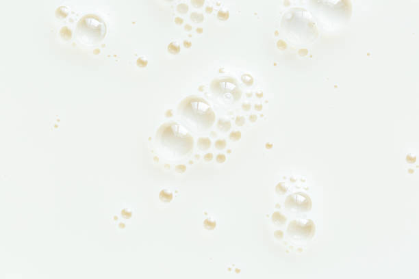 istock Macro milk texture,macro milk background,White surface of milk and bubbles and ripples from above birds eye view 2203772745