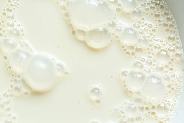 istock Macro milk texture,macro milk background,White surface of milk and bubbles and ripples from above birds eye view 2203772750