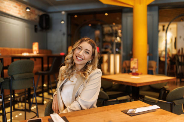 istock Beautiful young woman in restaurant 2203772773