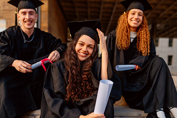istock Happy multiracial students celebrating graduation day 2203773552