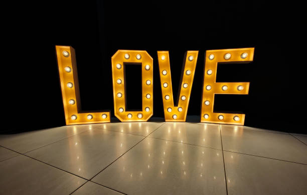 istock Illuminated LOVE letters with light bulbs. Wedding venue decoration 2203774258