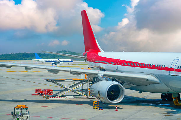istock Aircraft undergoing pre-flight maintenance, refueling and on-board catering for a passenger against the backdrop of the airfield and runway 2203774336