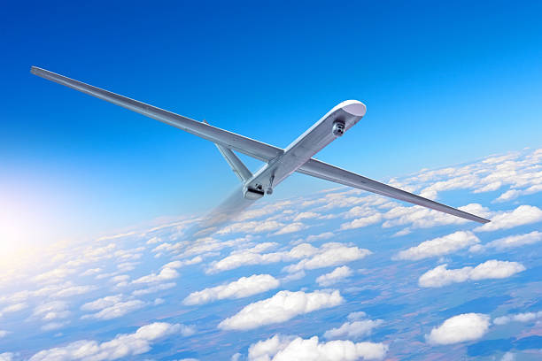 istock Unmanned military aircraft rapidly performs a maneuver gaining altitude with a turn background blue sky clouds. 2203775001