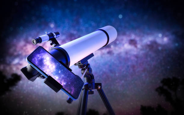 istock Telescope outdoors pointing sky with phone on stand showing image 2203777230